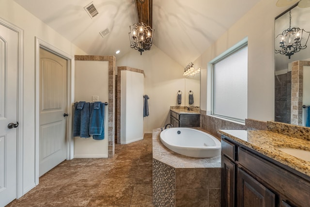 bathroom featuring tiled bath, vanity, lofted ceiling, and an inviting chandelier