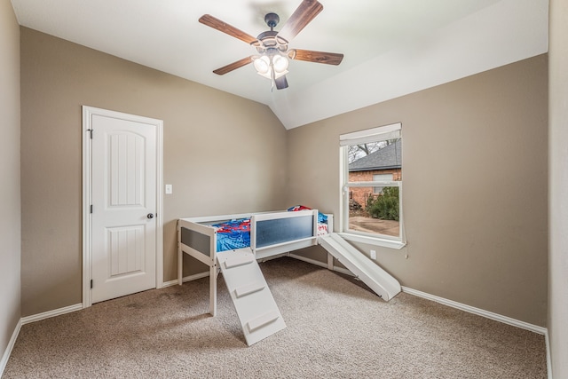 carpeted bedroom featuring ceiling fan and vaulted ceiling