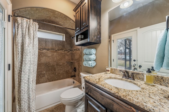 full bathroom featuring toilet, vanity, and shower / tub combo