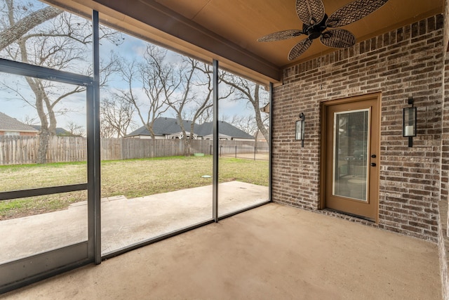 unfurnished sunroom with ceiling fan and wooden ceiling