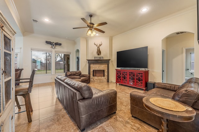 living room featuring ceiling fan, light tile patterned floors, and ornamental molding