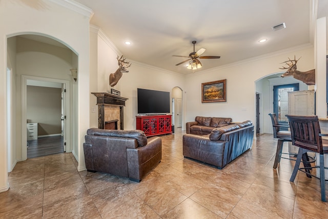 living room with ceiling fan and ornamental molding