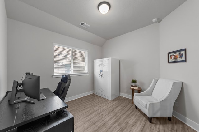 office space featuring light wood-type flooring and vaulted ceiling