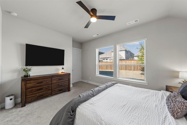 bedroom with light carpet, vaulted ceiling, and ceiling fan