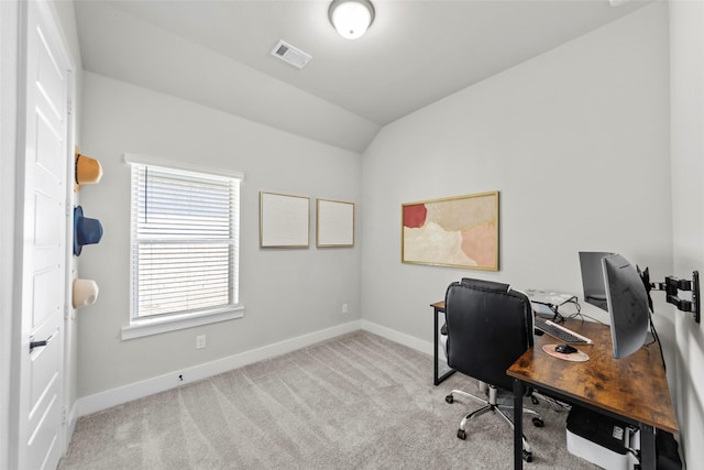 office space with lofted ceiling and light colored carpet