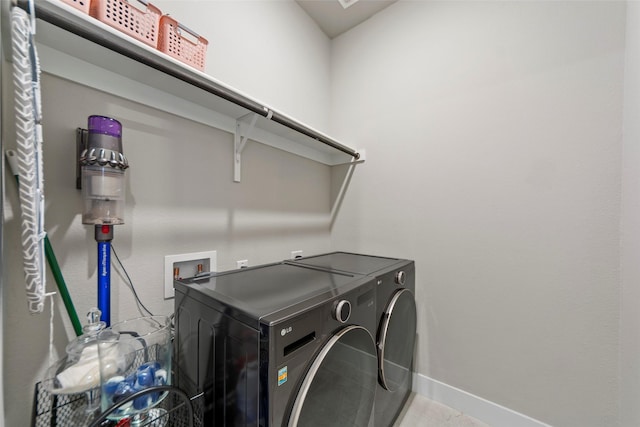 clothes washing area with washer and dryer