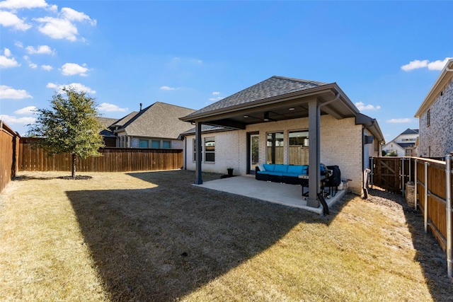 back of property featuring a lawn and a patio area