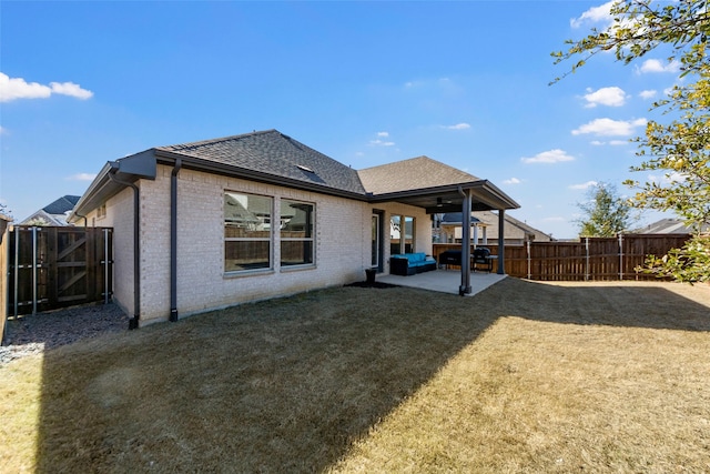 back of property featuring a yard, ceiling fan, and a patio area