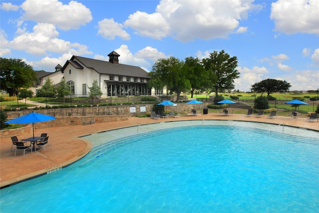 view of swimming pool with a patio