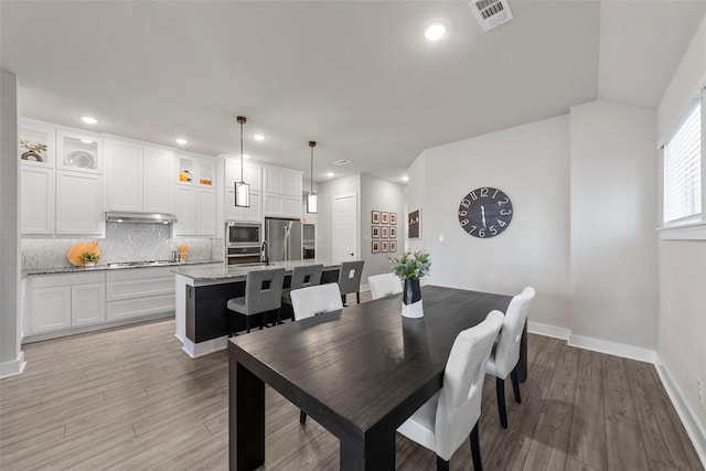 dining area with light hardwood / wood-style floors