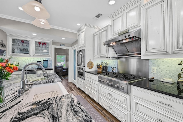 kitchen with sink, white cabinetry, stainless steel gas stovetop, and tasteful backsplash