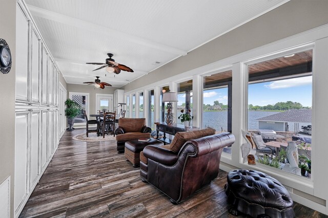 living room with dark wood-type flooring and a water view