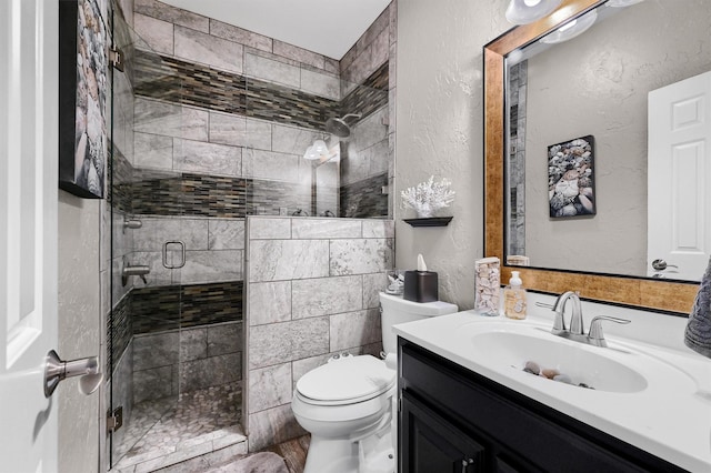 bathroom featuring toilet, walk in shower, and vanity