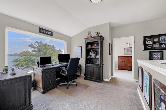 carpeted office space featuring vaulted ceiling