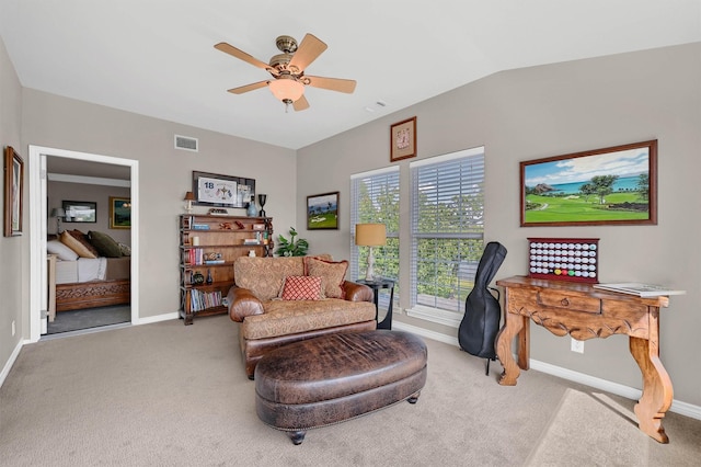 sitting room with lofted ceiling, ceiling fan, and carpet