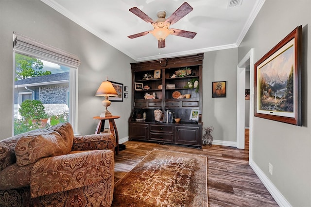 sitting room featuring dark hardwood / wood-style floors, ceiling fan, and ornamental molding