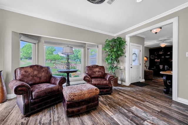 living room featuring dark wood-type flooring and crown molding