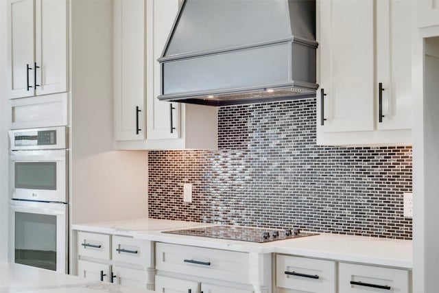 kitchen featuring sink, decorative backsplash, white cabinets, decorative light fixtures, and stainless steel dishwasher