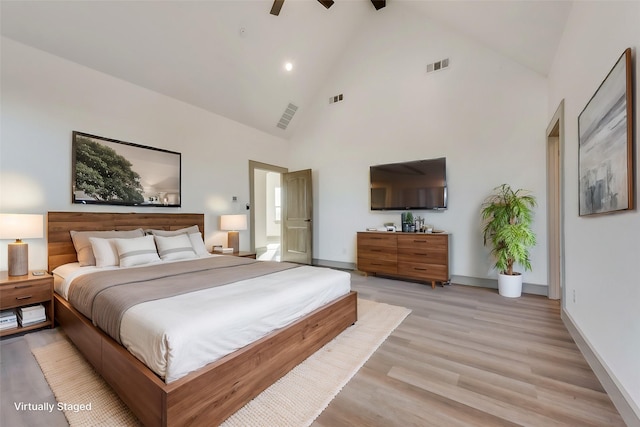 unfurnished room featuring beam ceiling, high vaulted ceiling, ceiling fan, and light wood-type flooring