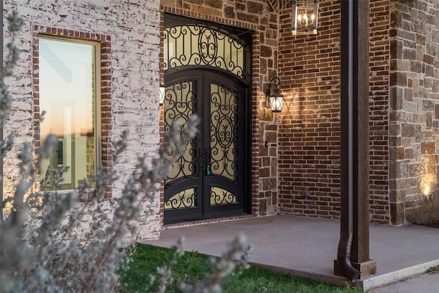 exterior entry at dusk featuring french doors