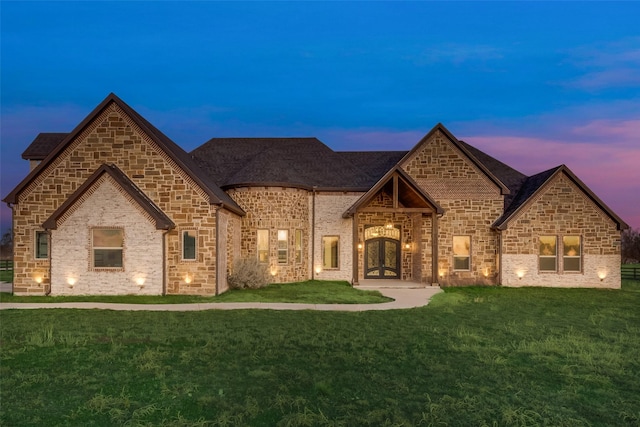 french country home with a yard and french doors