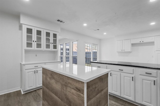 kitchen featuring white cabinetry, dark hardwood / wood-style floors, and a center island