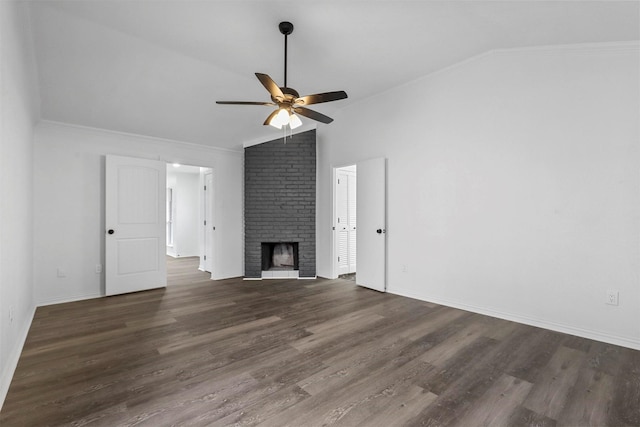 unfurnished living room with a brick fireplace, dark wood-type flooring, lofted ceiling, and ceiling fan