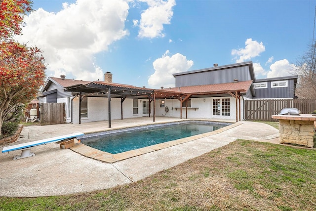 rear view of house featuring a fenced in pool, a patio area, and a pergola