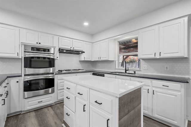 kitchen featuring sink, white cabinets, appliances with stainless steel finishes, and a kitchen island