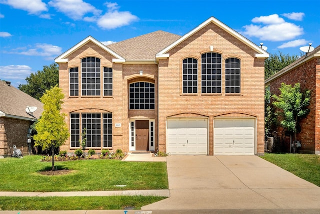 view of property with a garage and a front lawn