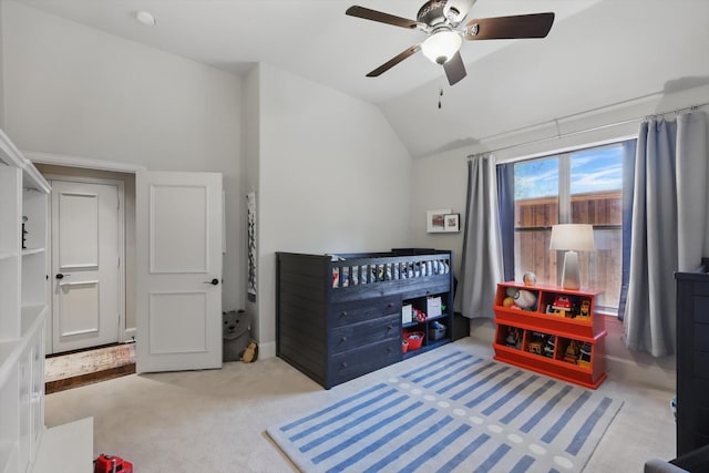 bedroom featuring lofted ceiling, light colored carpet, and ceiling fan