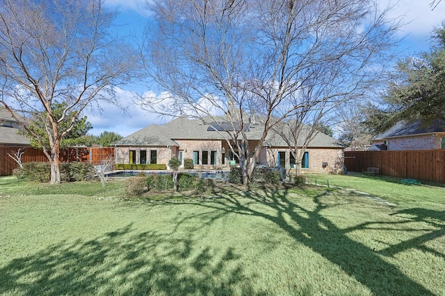 back of house with a lawn