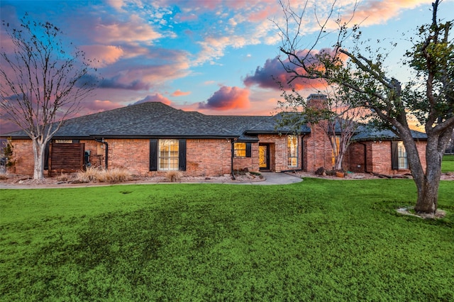 back house at dusk with a yard