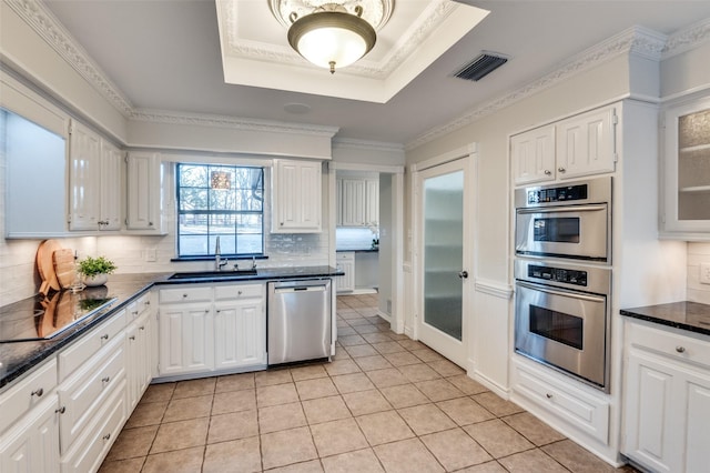 kitchen featuring sink, white cabinetry, decorative backsplash, and stainless steel appliances