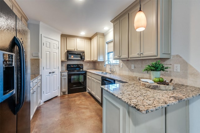 kitchen with kitchen peninsula, hanging light fixtures, sink, light stone countertops, and black appliances