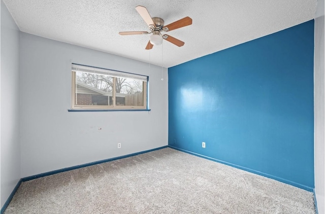 carpeted empty room featuring a textured ceiling and ceiling fan