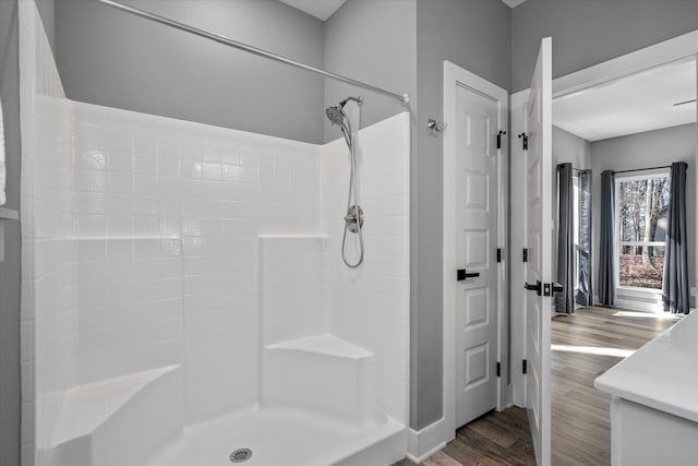 bathroom with hardwood / wood-style floors and walk in shower