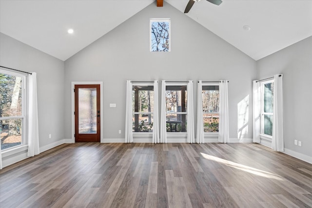 unfurnished living room featuring high vaulted ceiling, hardwood / wood-style floors, and beamed ceiling