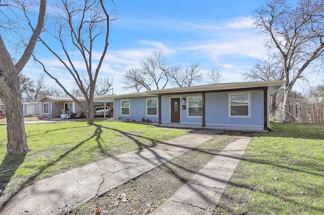 single story home featuring a front lawn and a carport