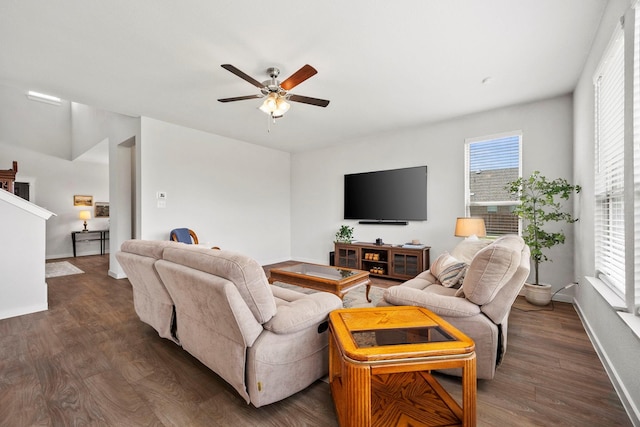 living room with ceiling fan and dark hardwood / wood-style flooring