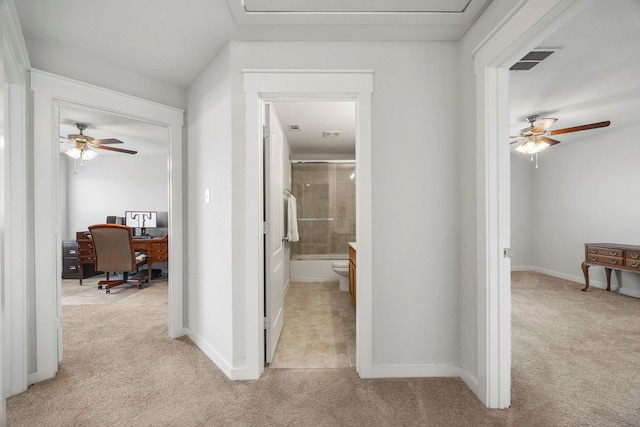 hall with light colored carpet