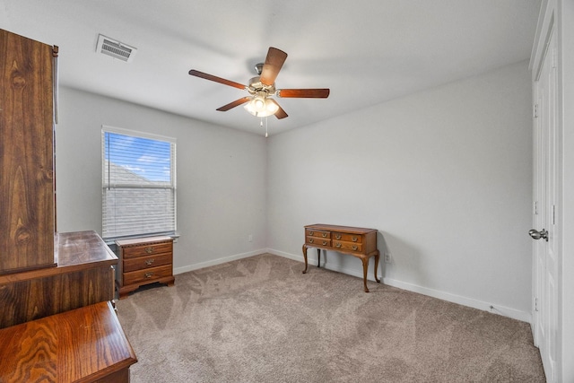 interior space with ceiling fan and light colored carpet