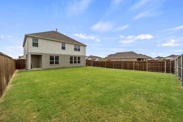 back of house with a lawn