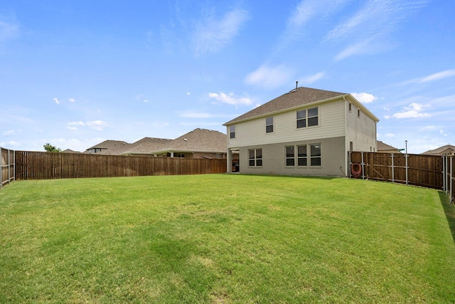 back of house featuring a lawn