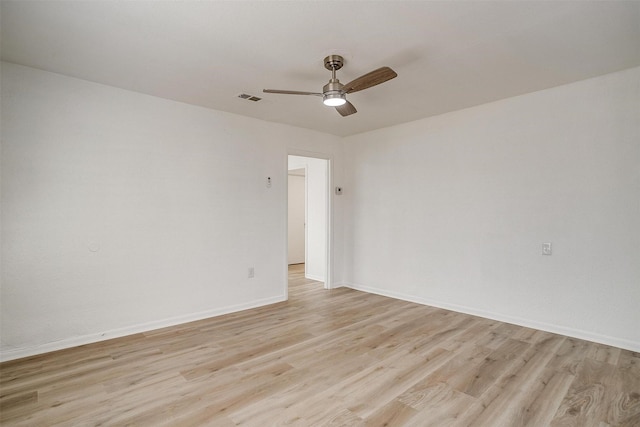 spare room with ceiling fan and light wood-type flooring