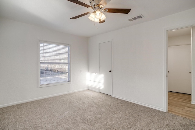 unfurnished bedroom featuring carpet floors, a closet, and ceiling fan