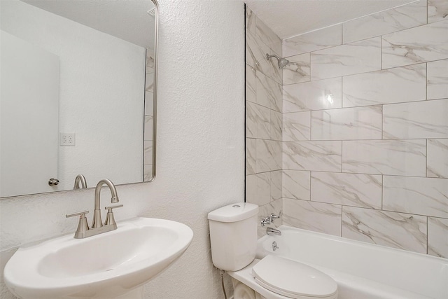 full bathroom featuring tiled shower / bath, sink, and toilet