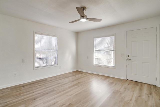 interior space featuring a textured ceiling, light hardwood / wood-style flooring, and ceiling fan