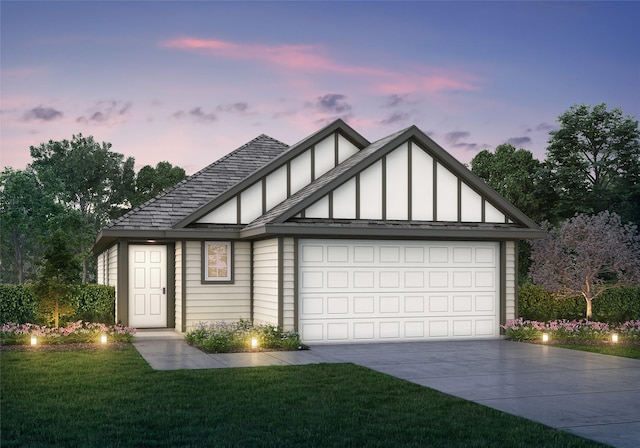 view of front of home with a yard and a garage