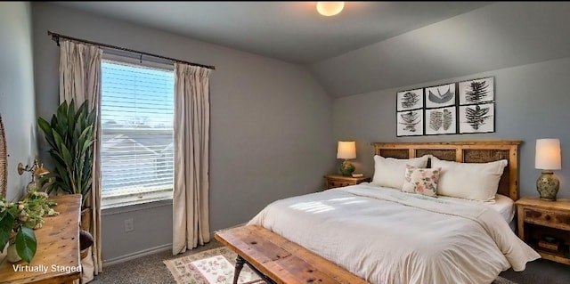 carpeted bedroom featuring vaulted ceiling and multiple windows